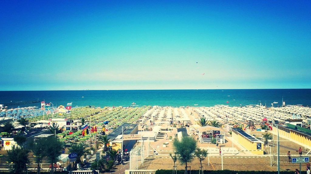 Spiaggia di Rimini centro con ombrelloni colorati e mare azzurro, equivale al relax di lavorare con WordPress